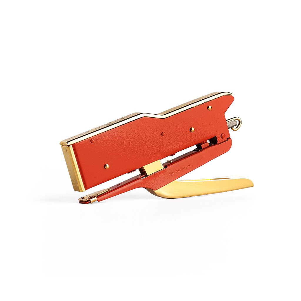 Handheld Zenith 548/E 2 stapler with a vibrant orange-red body and a gold handle