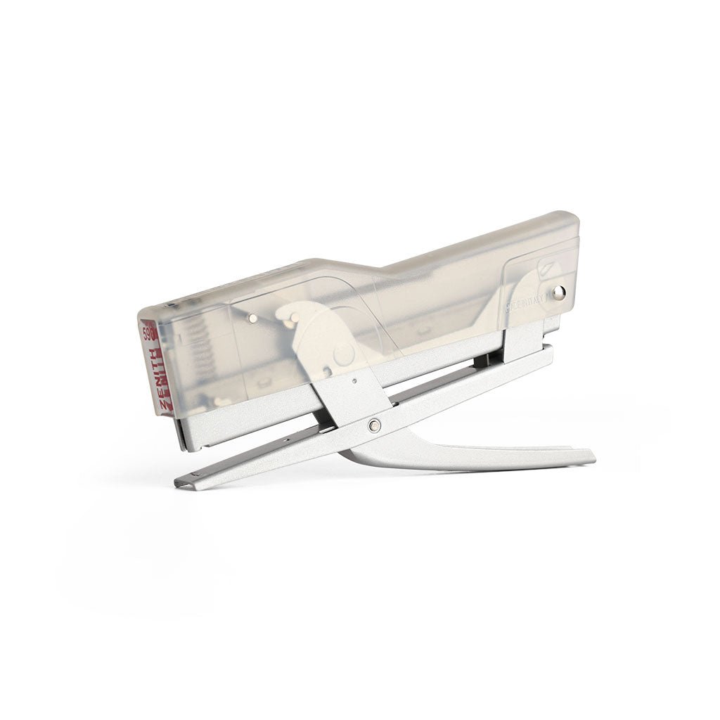 Handheld Zenith 590 stapler with transparent body and metal base on a white background