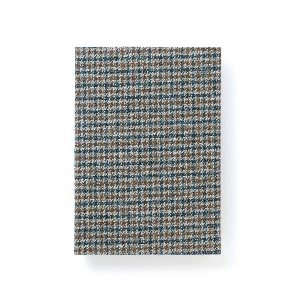 Blue and greenish houndstooth fabric notebook cover on white background