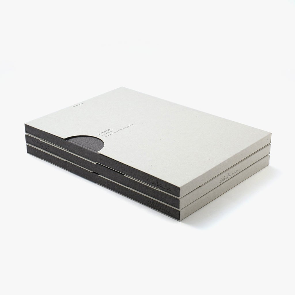 Stack of grey notebooks in gray packaging on a white background