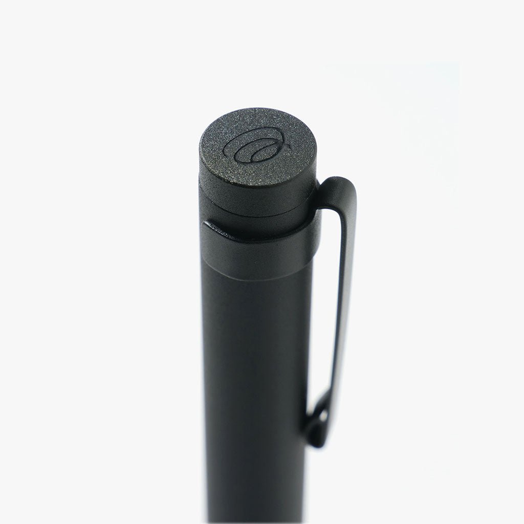 Black pen with a textured cap on a white background