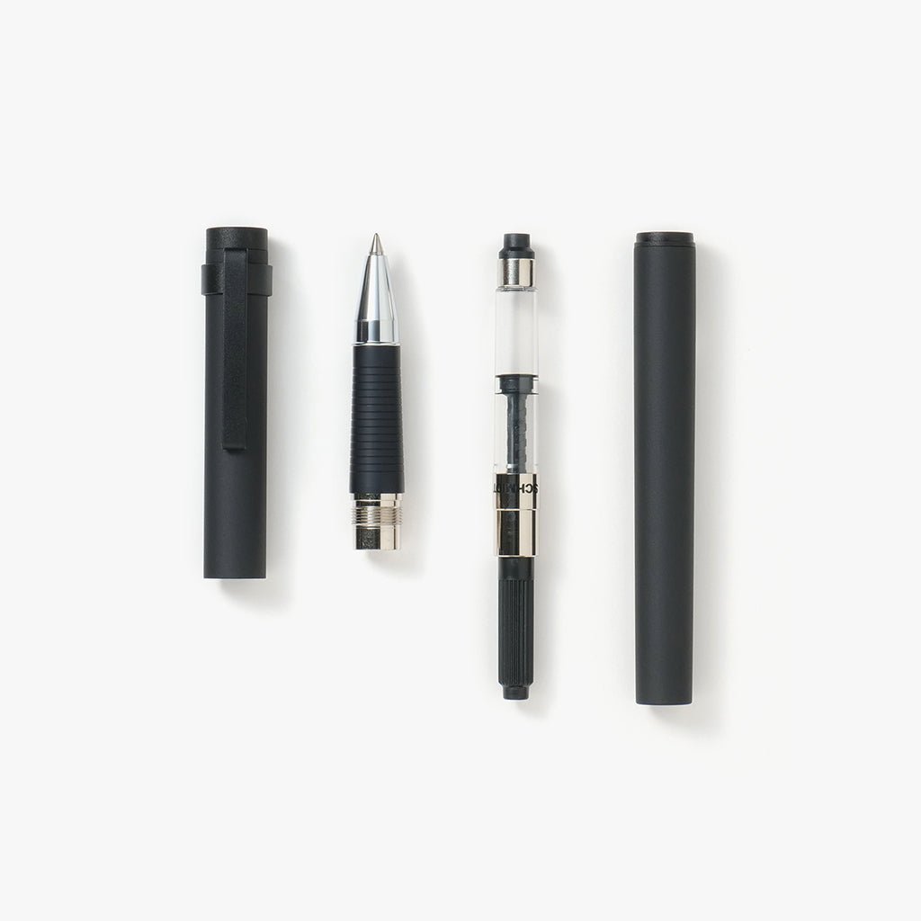 Rollerball pen taken apart with converter on white background
