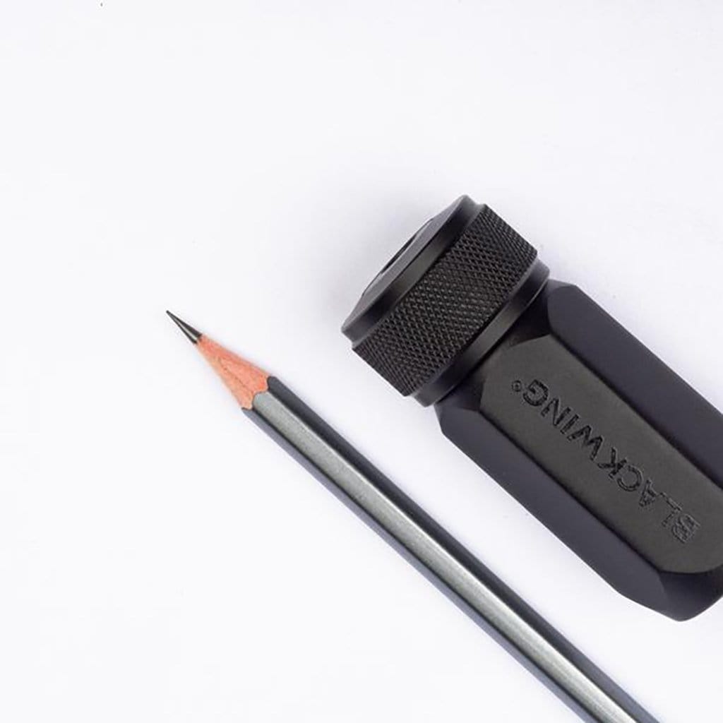 Blackwing pencil sharpener with a pencil on a white background