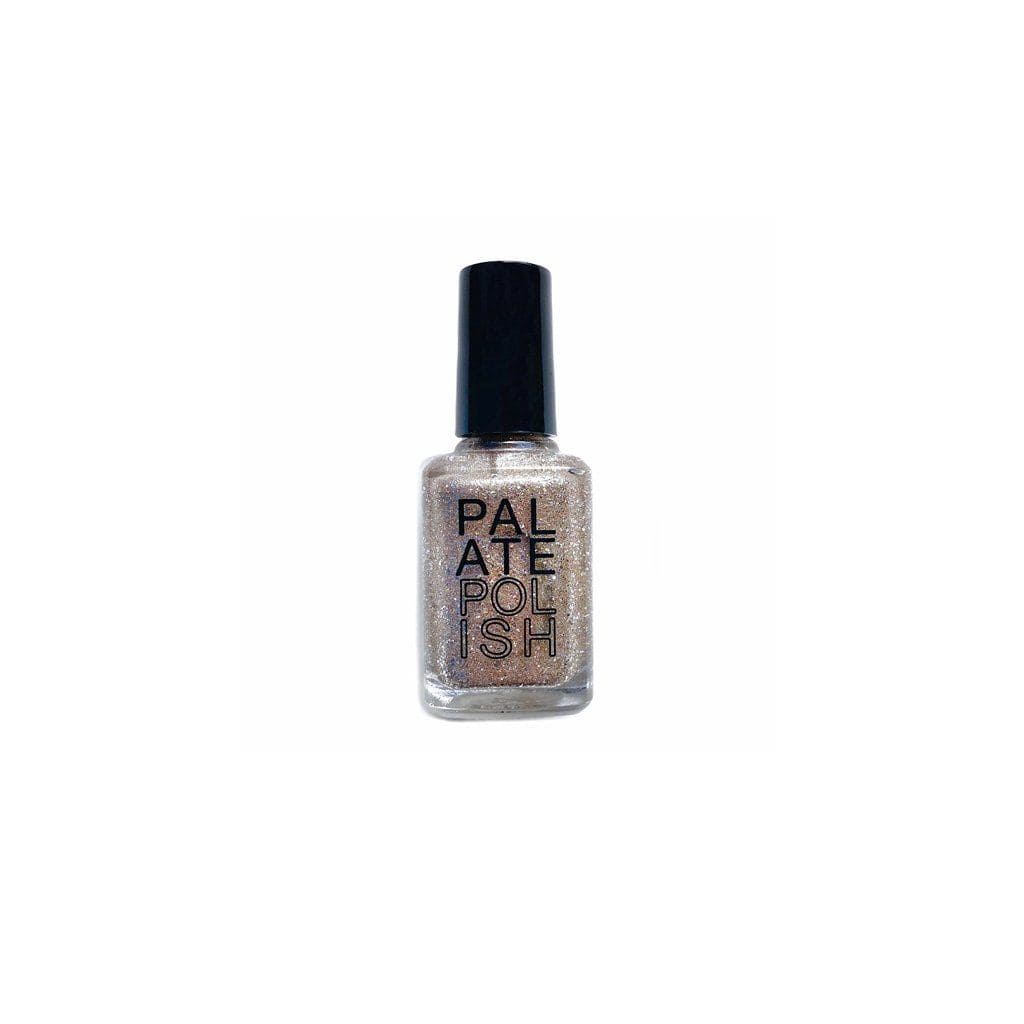 Bottle of shimmery silver gold nail polish on white background