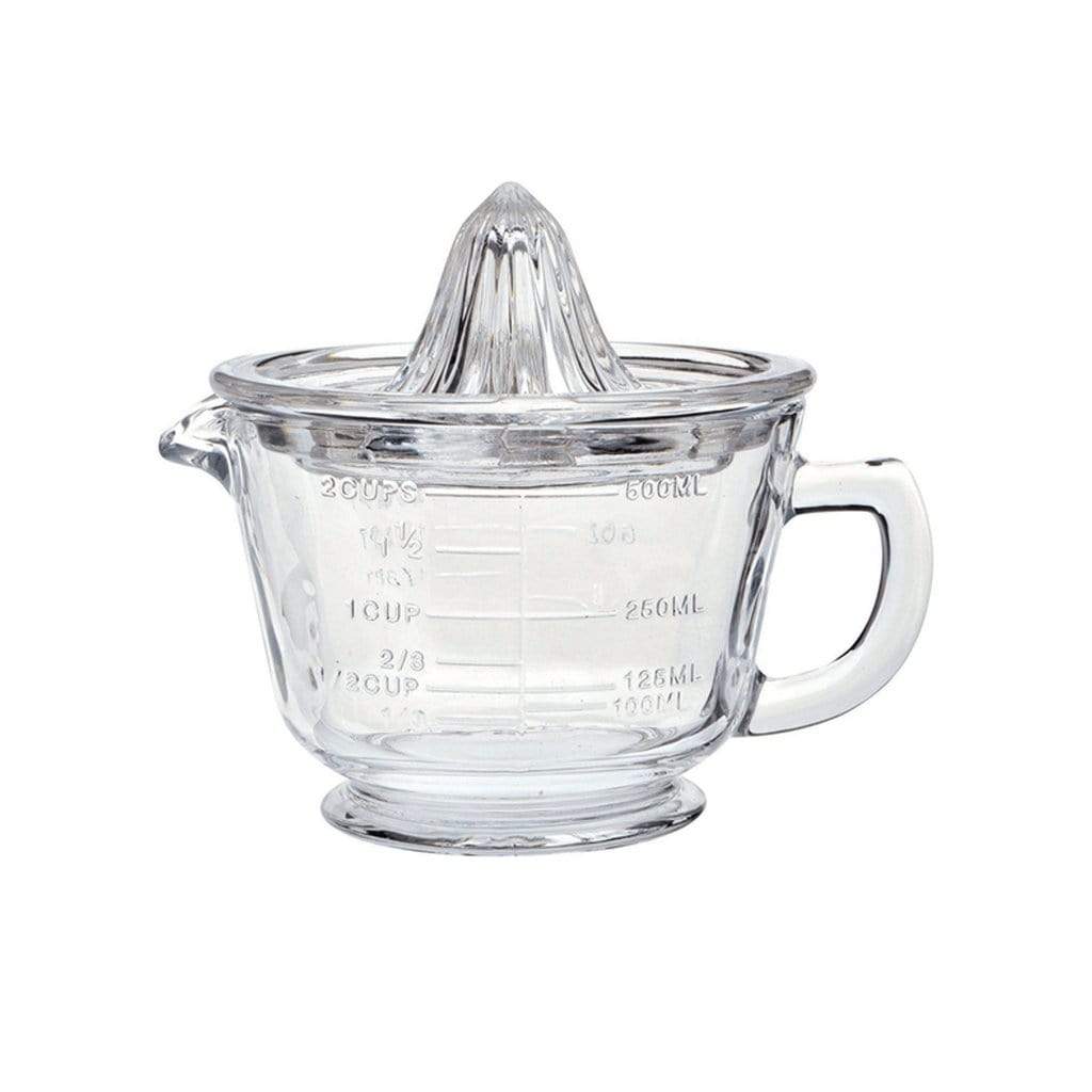 A clear glass measuring jug shown with a citrus juicer that rests on top.