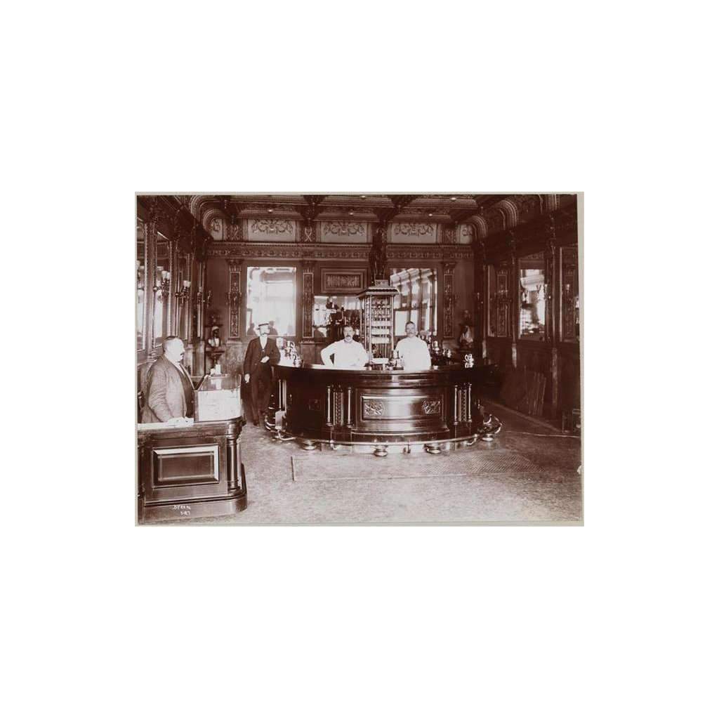 Vintage black and white photo of a bar interior with patrons and staff.
