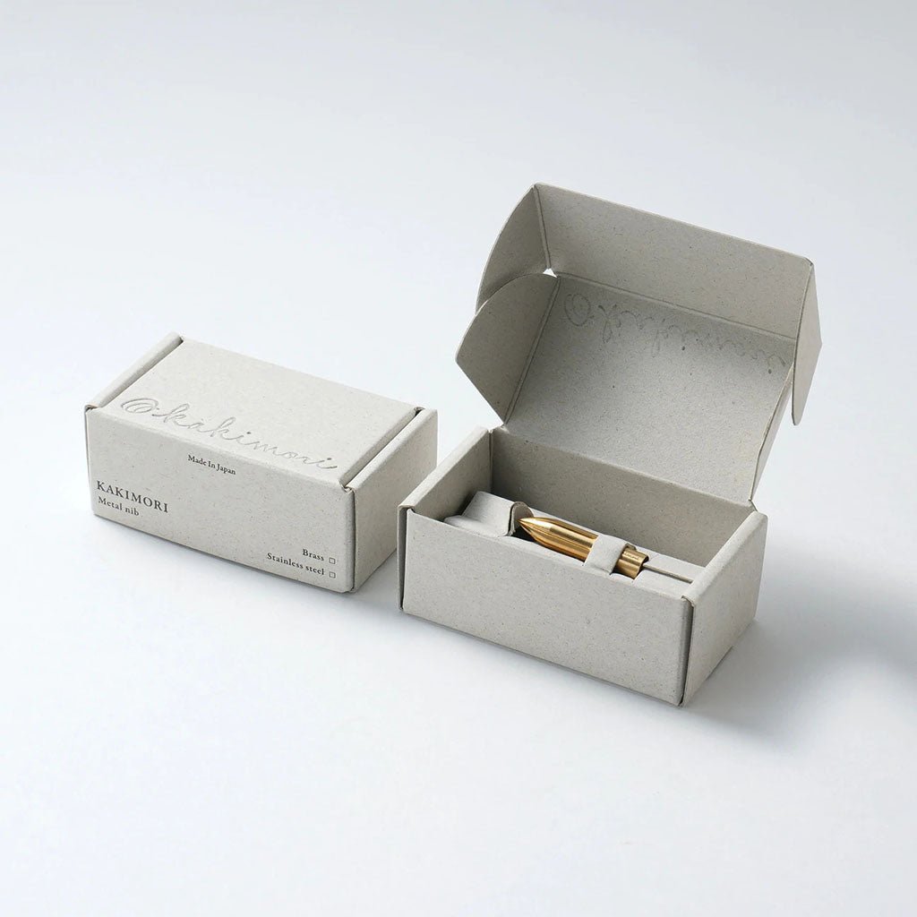 Small beige box with a gold nib on a white background