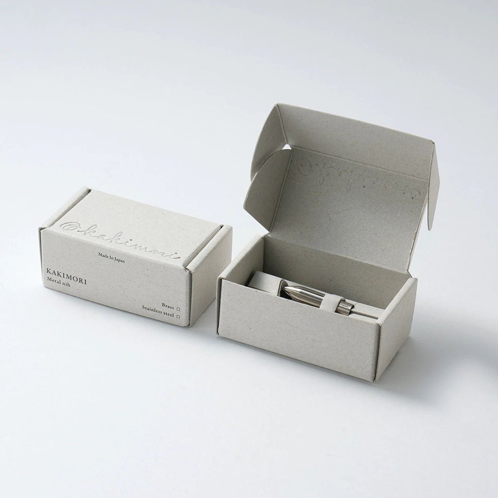 Small beige box with a silver nib on a white background