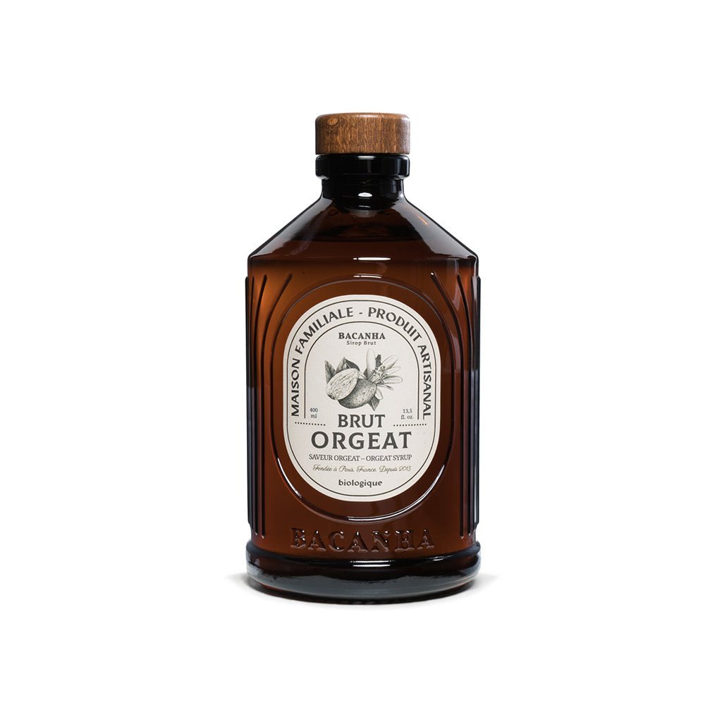 Brown bottle of orgeat syrup with a white label on a white background