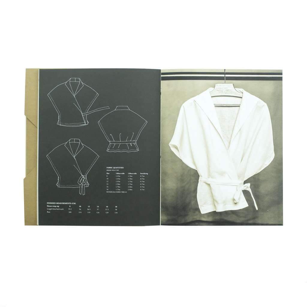Open sewing pattern workbook on white background