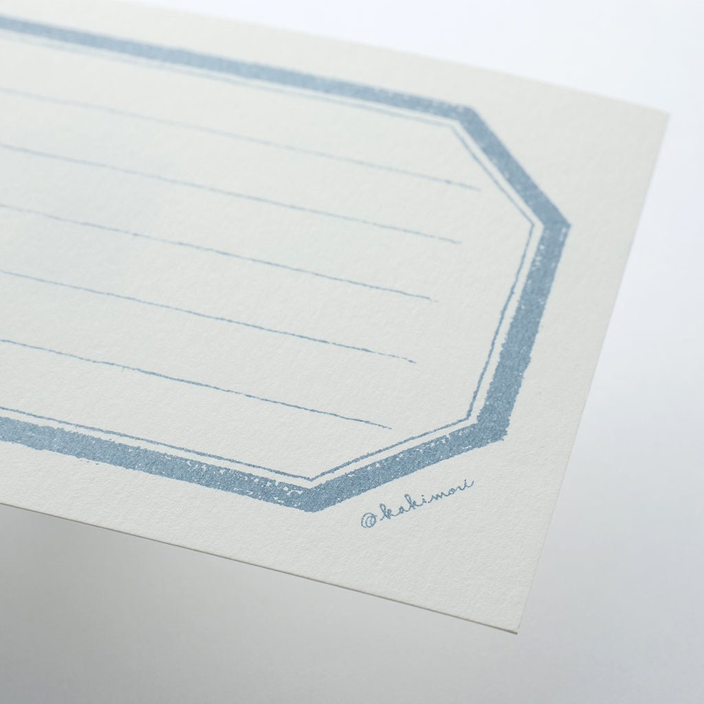 Sheet of lined notecard with a blue border on a white background