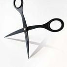 Black stainless steel scissors with 'TOOLS to LIVEBY' branding on blades on a light background.
