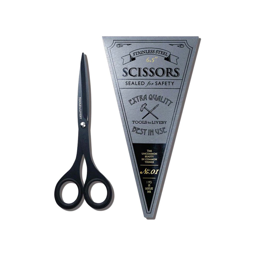 Black stainless steel scissors shown next to their triangular silver-gray branded packaging label on a plain white background.
