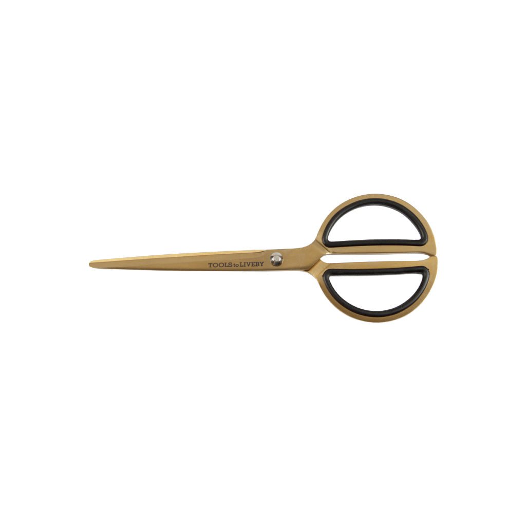 Gold and black scissors with rounded handles on white background