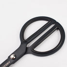 Matte black scissors with rounded handles on white background