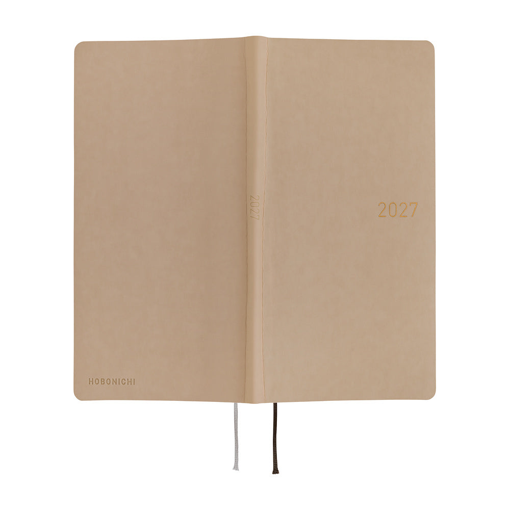 An exterior view of a planner with a sandy beige softcover that is flexible and slightly puffy. The year 2027 is embossed in gold on the front. 
