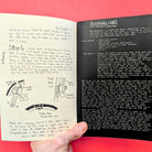 Open book with handwritten notes and diagrams on a red background