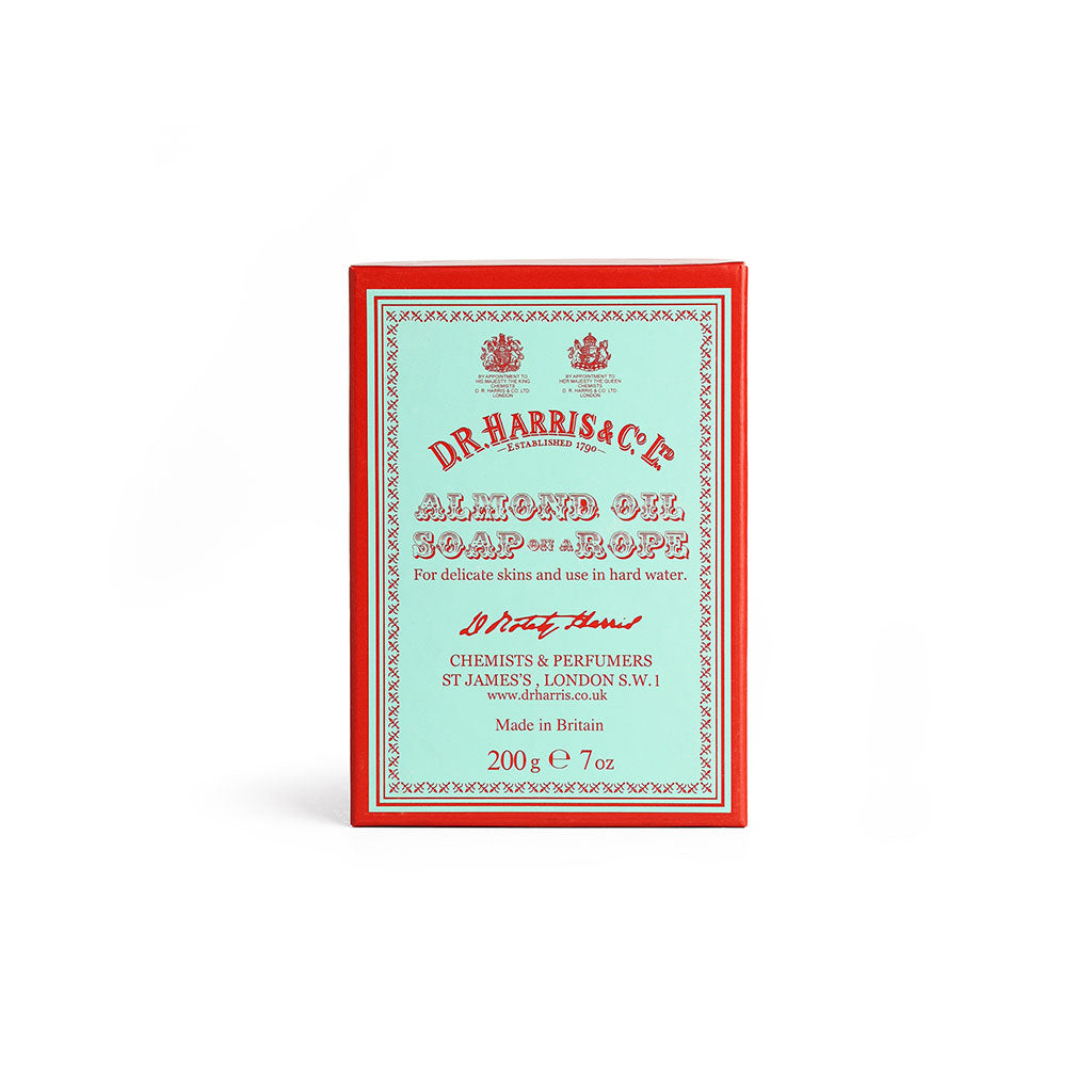 Box of almond oil soap on a rope on a white background