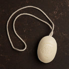 D. R. Harris soap on a rope on a dark brown background