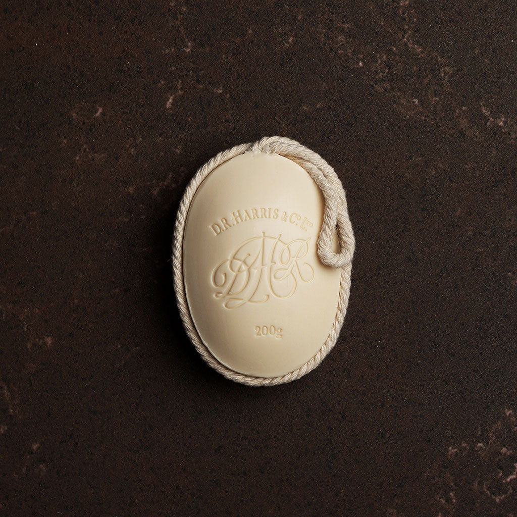 D. R. Harris soap on a rope on a dark brown background