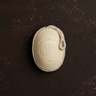 D. R. Harris soap on a rope on a dark brown background