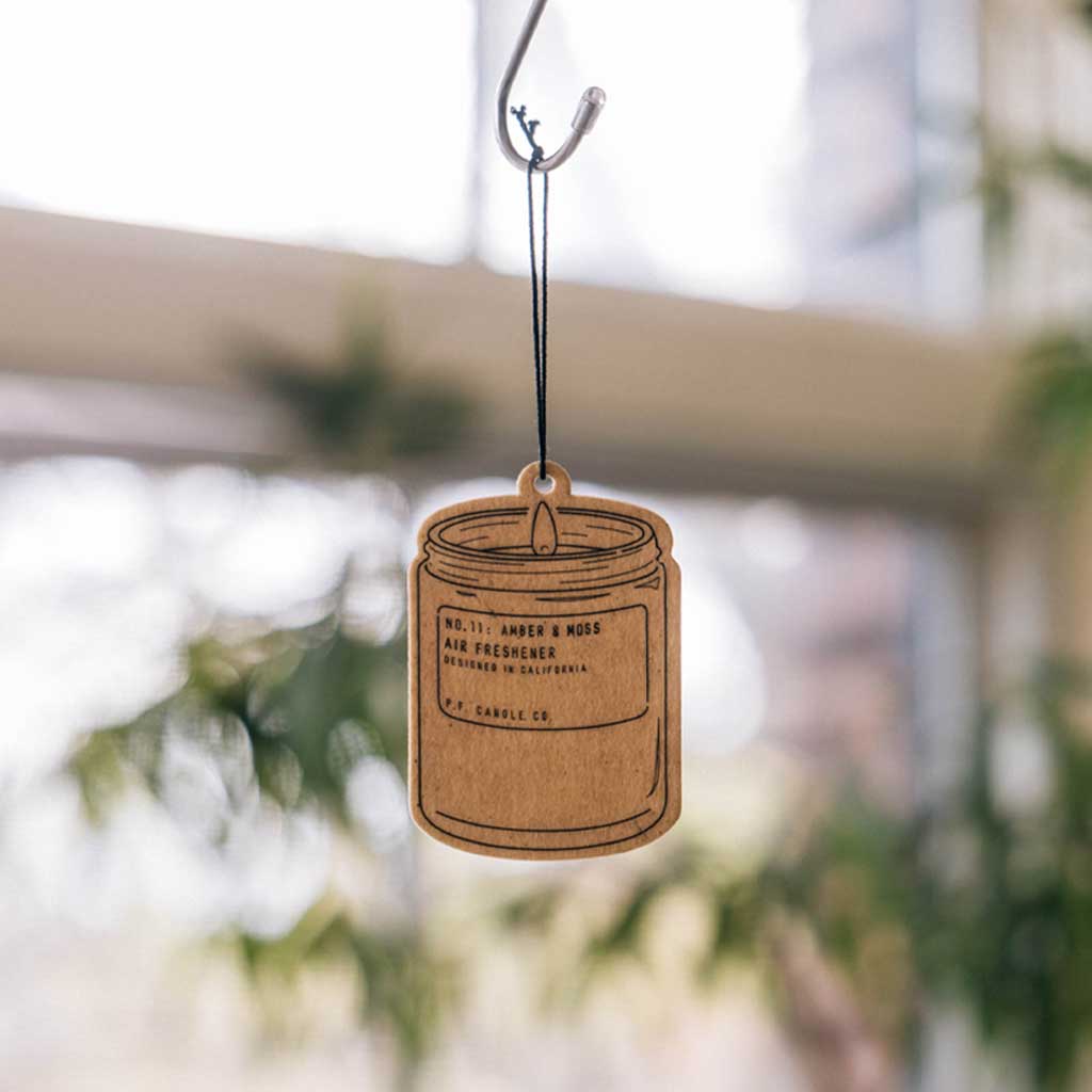 Hanging air freshener with a blurred indoor background