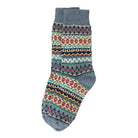 A colorful cotton sock in a fair isle pattern in shades of denim blue, cream, black, and red.