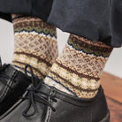 Close-up of model wearing cotton fair isle socks and black shoes.