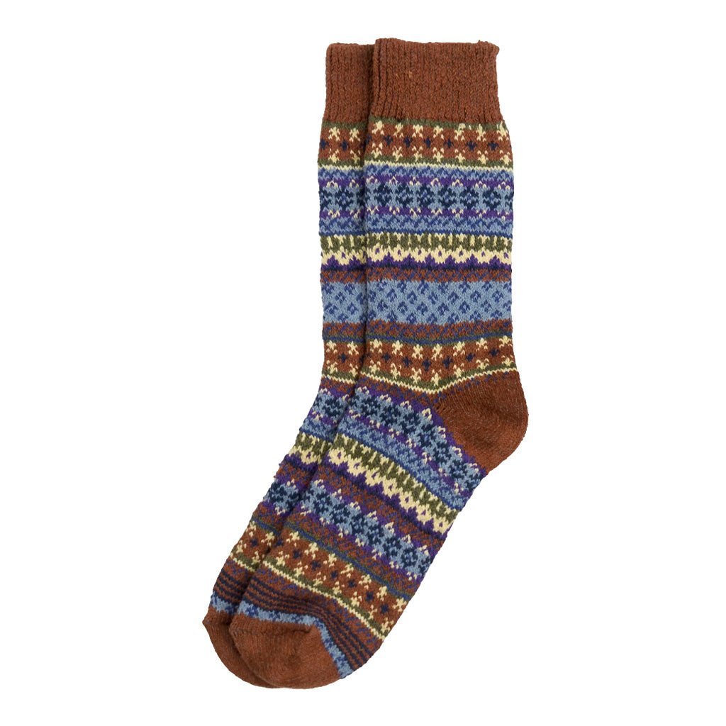 A colorful cotton sock in a fair isle pattern in shades of rust brown, cream, and blue.