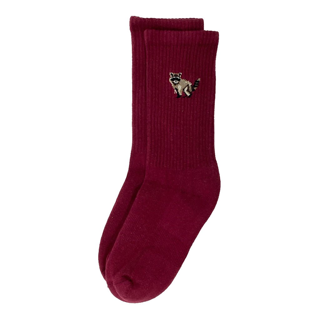A pair of maroon crew socks with embroidered raccoon on ankle.