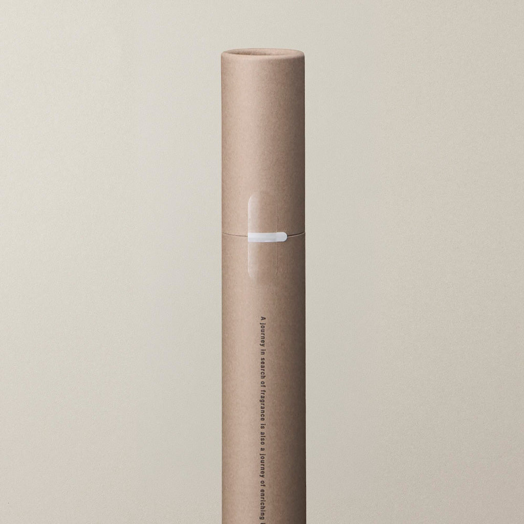 Close-up of a kraft paper tube of incense sticks.