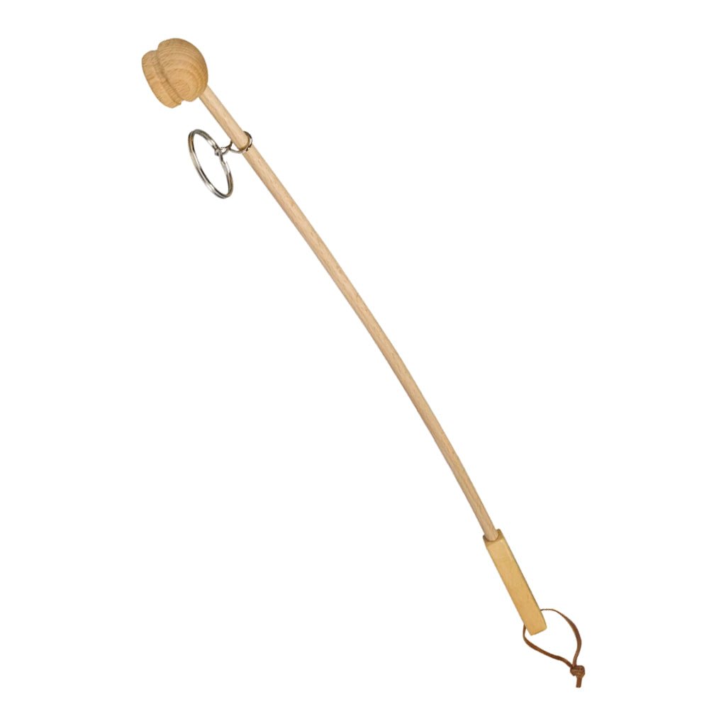 Wooden back cream applicator with metal ring and leather loop on white background