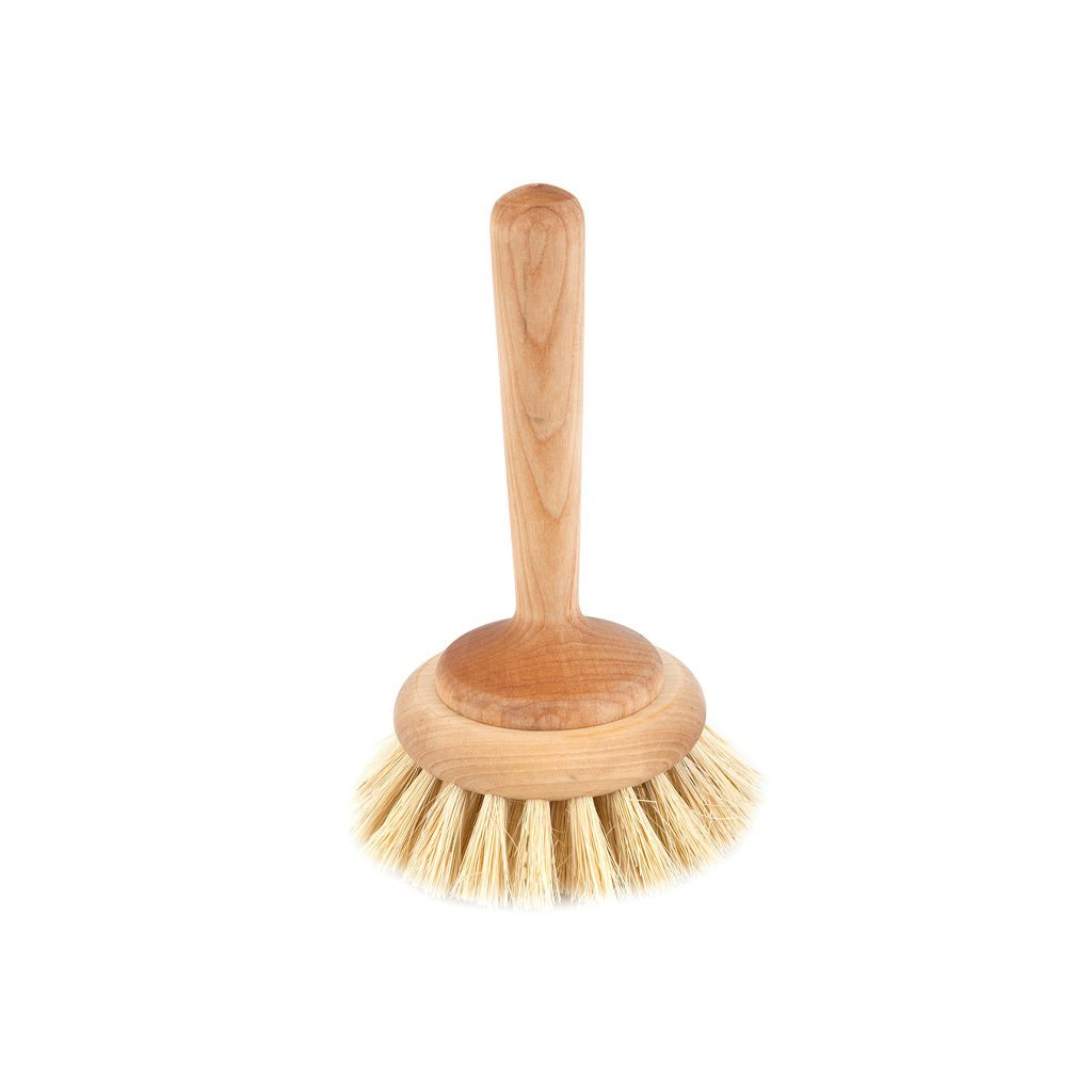 A wooden bathtub cleaning brush with light natural bristles on white background