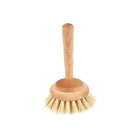 A wooden bathtub cleaning brush with light natural bristles on white background