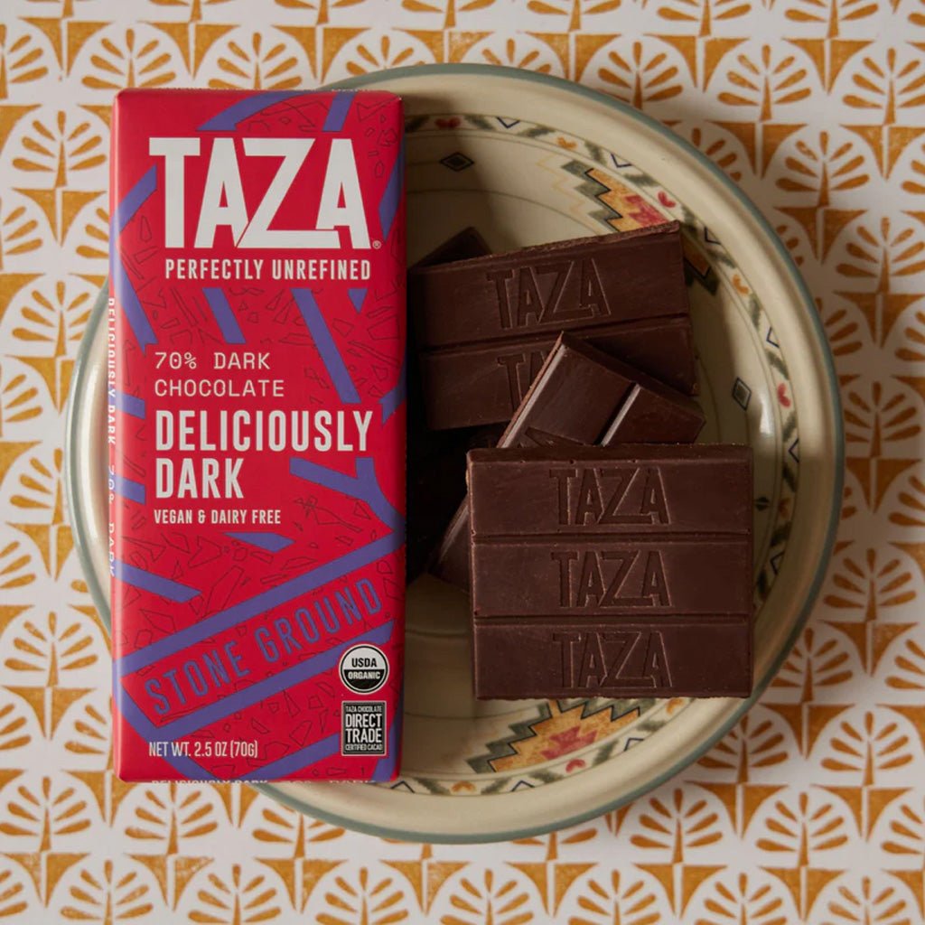 Taza chocolate bars with packaging on a patterned surface