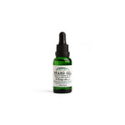 Green bottle of D. R. Harris beard oil on white background
