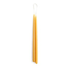 A set of two thin yellow beeswax taper candles on white background