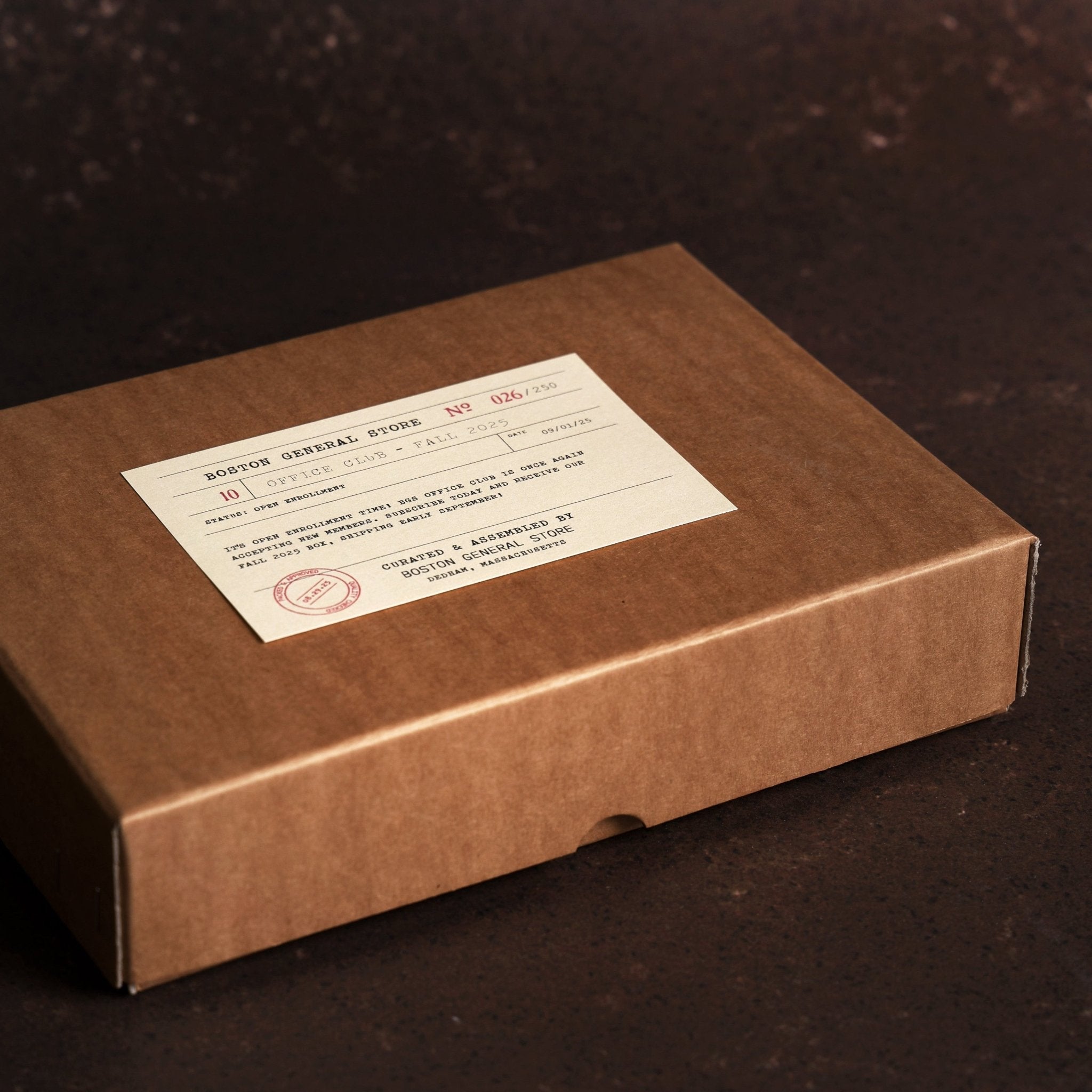Brown cardboard box with a printed Boston General Store Office Club label on the lid.