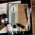 Collection of stationery items including paper, ink, and writing tools in a box.