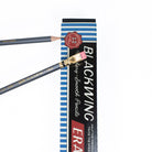Blackwing pencil box behind two gray pencils.