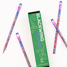 Box of Blackwing pencils next to loose pencils.