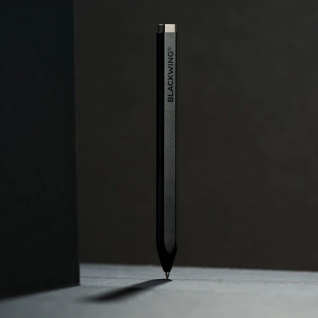 Black aluminum pen with 'BLACKWING' branding on a dark background