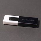 White eraser pulled out of black eraser holder with Blackwing branding on gray surface