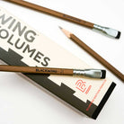 A close-up photo showing the blackwing logo imprinted in black on brown Volumes 21 pencil that has a silver ferrule and black eraser. 