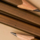 A very close-up photo showing the detailed joinery in the wood grain of the Blackwing Volumes 21 woodworking pencil. 