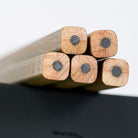 A close-up photo showing the ends of five unsharpened Blackwing Volumes 21 pencils The pencils have a unique, square shape. 