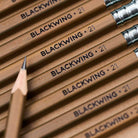 A close-up photo showing the blackwing logo imprinted in black on brown Volumes 21 pencils.