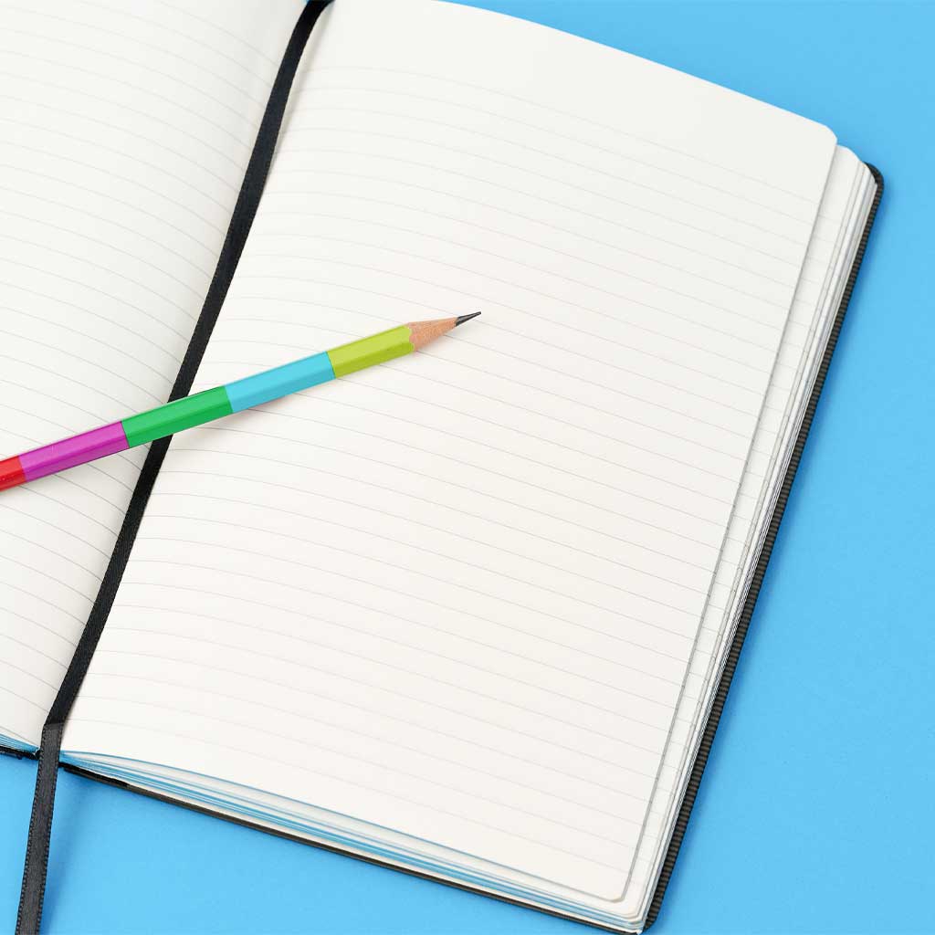 Open Blackwing 343 notebook with pencil on blue background