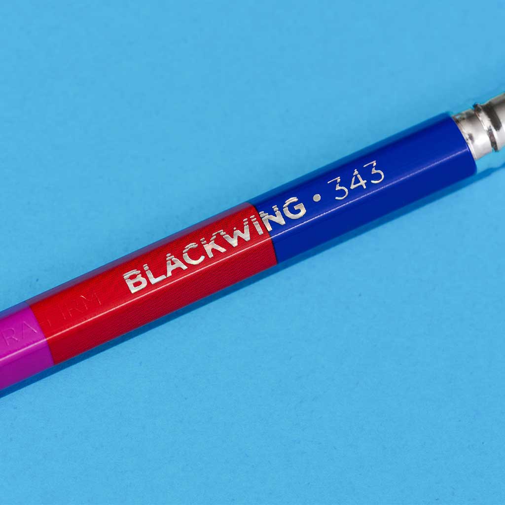Blue and red Blackwing 343 pencil on a blue background