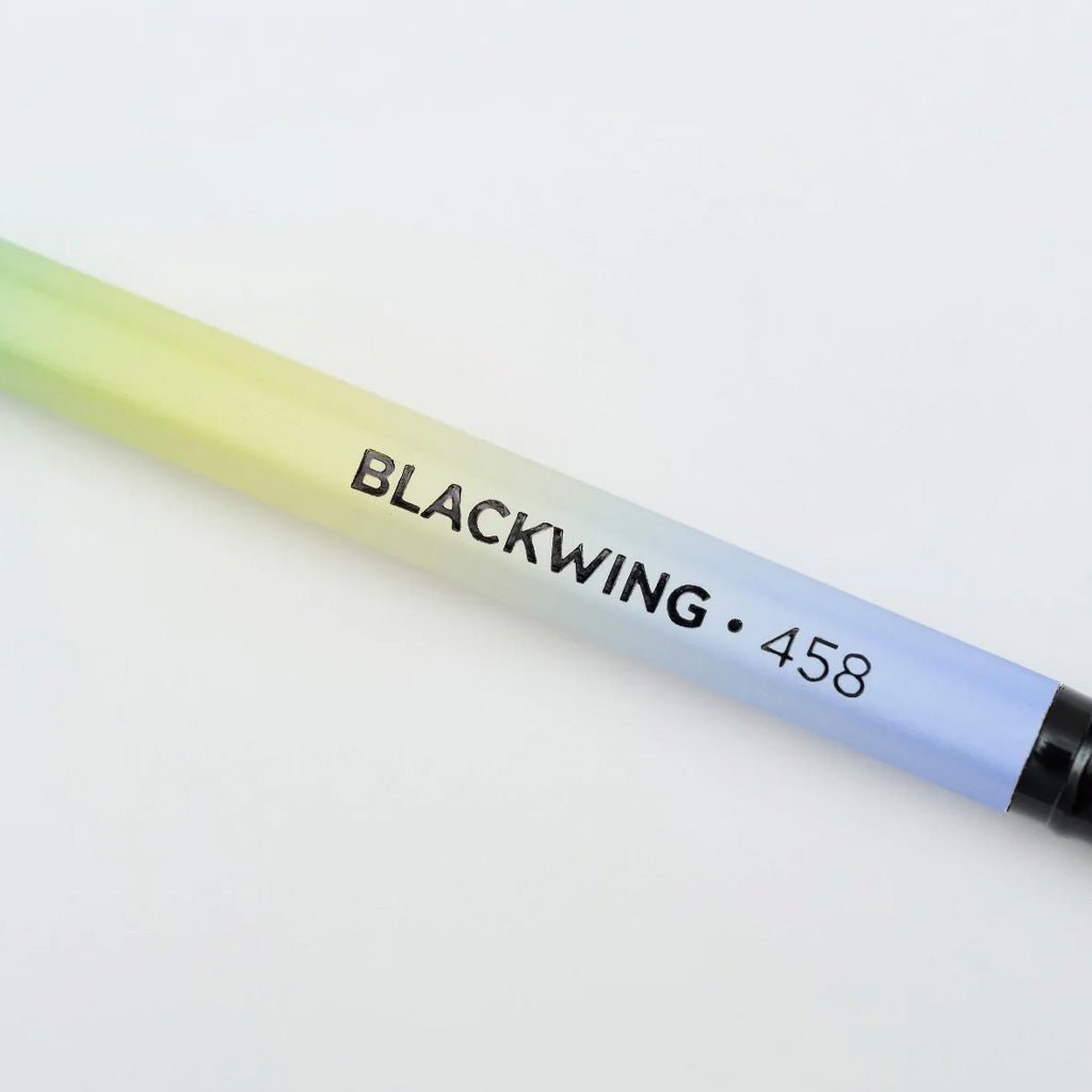 Close up of Blackwing 458 pencil with gradient design on light background
